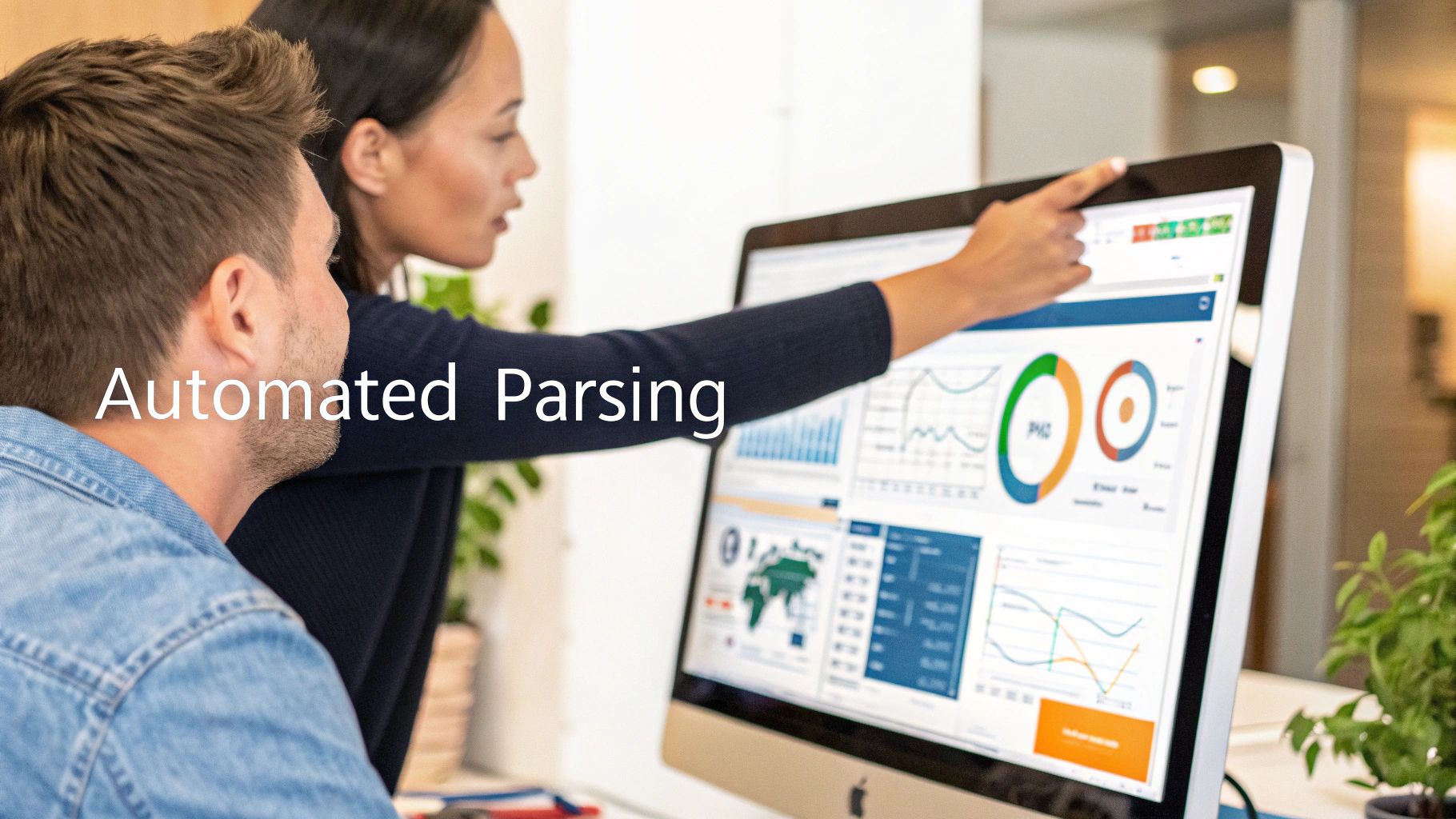 A woman points at a computer screen showing data charts and "Automated Parsing" text, with a man watching.